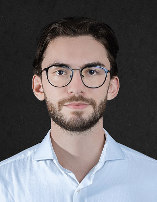 Arthur Haj, man with dark hair, short beard, round glasses, light-colored shirt, neutral expression, Analyst.