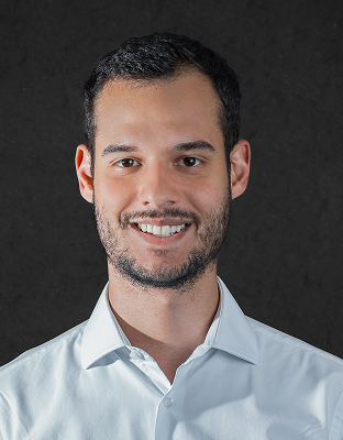 Matteus Marchioni, man with short dark hair, short beard, wearing a light-colored dress shirt, smiling, Executive Director.