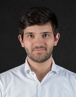 Victor Santini, man with short dark hair, light stubble, light-colored collared shirt, slight smile, Associate Director.