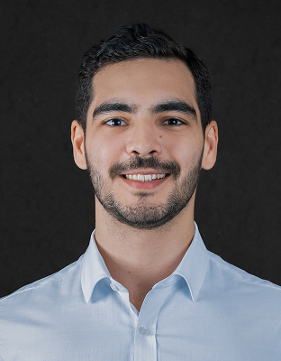 Victor Silveira, smiling, with beard, wearing a light-colored shirt.